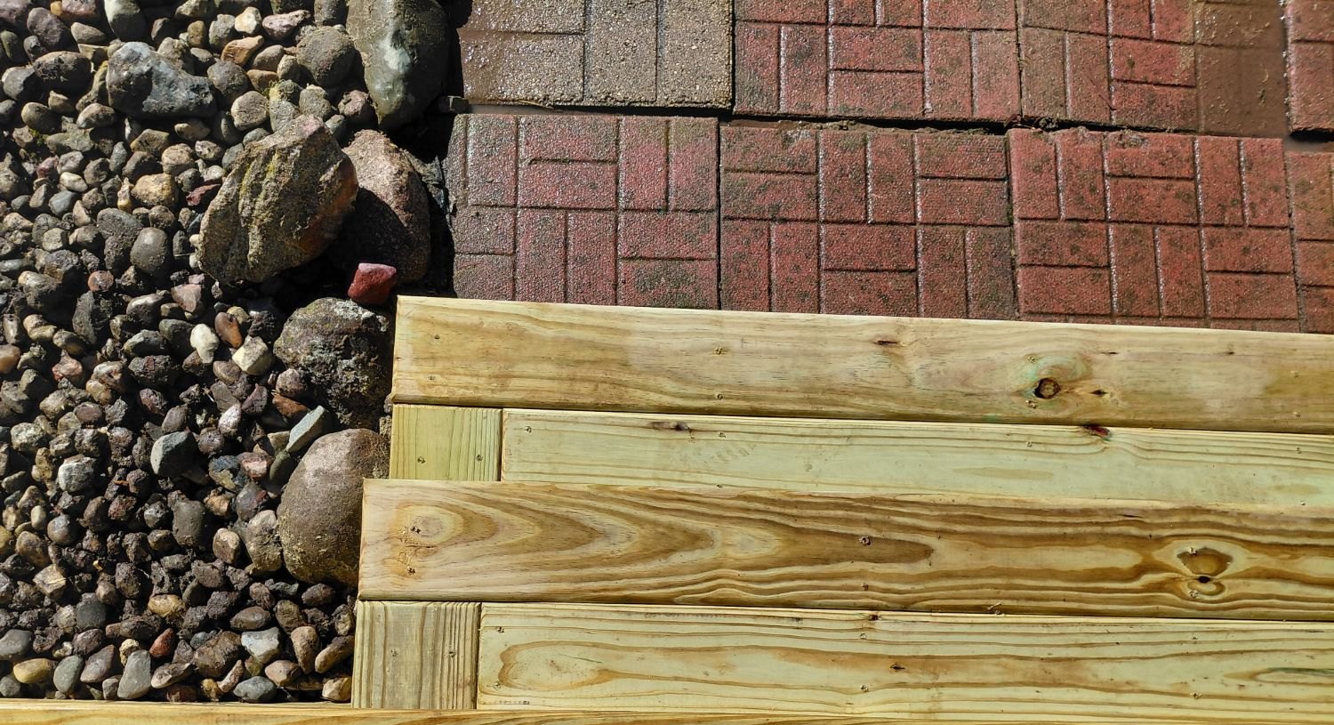 Looking straight down on the steps landing on the brick paver patio