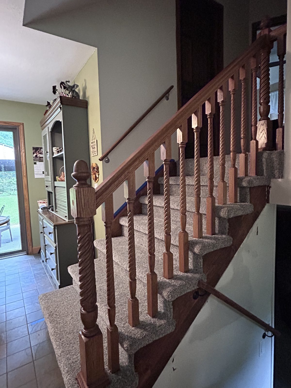Completed interior staircase remodel with new carpet runner and refinished oak handrail